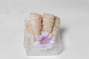 In Indonesia, this cake is known as cumcum cake. A cake shaped like a trumpet, or an ice cream cone. The perfect combination of a dry cake studded with sugar, plus a delicious cream vanilla filling. photo
