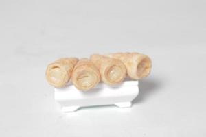 In Indonesia, this cake is known as cumcum cake. A cake shaped like a trumpet, or an ice cream cone. The perfect combination of a dry cake studded with sugar, plus a delicious cream vanilla filling. photo