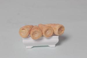 In Indonesia, this cake is known as cumcum cake. A cake shaped like a trumpet, or an ice cream cone. The perfect combination of a dry cake studded with sugar, plus a delicious cream vanilla filling. photo