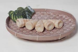 In Indonesia, this cake is known as cumcum cake. A cake shaped like a trumpet, or an ice cream cone. The perfect combination of a dry cake studded with sugar, plus a delicious cream vanilla filling. photo
