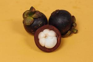 Mangosteen is a tropical fruit from Asia. Mangosteen has a distinctive sweet and sour taste. Mangosteen also has a myriad of benefits, properties, and nutritional content that is useful for health. photo