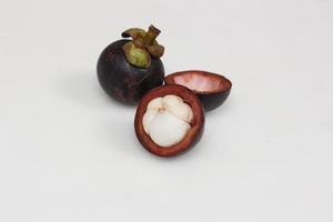 Mangosteen is a tropical fruit from Asia. Mangosteen has a distinctive sweet and sour taste. Mangosteen also has a myriad of benefits, properties, and nutritional content that is useful for health. photo