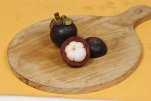 Mangosteen is a tropical fruit from Asia. Mangosteen has a distinctive sweet and sour taste. Mangosteen also has a myriad of benefits, properties, and nutritional content that is useful for health. photo