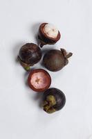 Mangosteen is a tropical fruit from Asia. Mangosteen has a distinctive sweet and sour taste. Mangosteen also has a myriad of benefits, properties, and nutritional content that is useful for health. photo