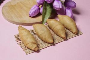 Chocolate bananas from raw materials covered with rolls of pastry dough sheets. Molen bananas with pastries are usually served with a cup of hot coffee or tea. Focus blur photo