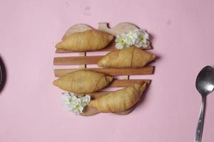 Chocolate bananas from raw materials covered with rolls of pastry dough sheets. Molen bananas with pastries are usually served with a cup of hot coffee or tea. Focus blur photo
