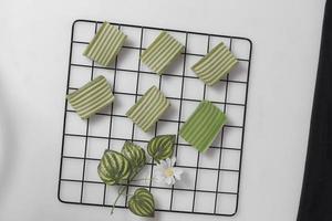 Original and pandan flavored layer cake. Layer cake is ready to accompany your morning with a glass of tea. Indonesian cake. We often see it as a side dish during Eid. Sweet and soft cake. Focus blur. photo