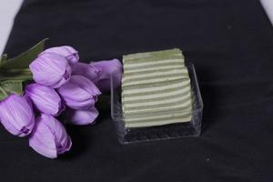 Original and pandan flavored layer cake. Layer cake is ready to accompany your morning with a glass of tea. Indonesian cake. We often see it as a side dish during Eid. Sweet and soft cake. Focus blur. photo