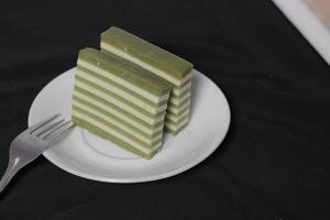 Original and pandan flavored layer cake. Layer cake is ready to accompany your morning with a glass of tea. Indonesian cake. We often see it as a side dish during Eid. Sweet and soft cake. Focus blur. photo