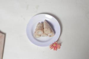 In Indonesia, this cake is known as cumcum cake. A cake shaped like a trumpet, or an ice cream cone. The perfect combination of a dry cake studded with sugar, plus a delicious cream vanilla filling. photo