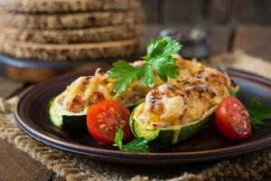 Stuffed zucchini with chicken, tomatoes and onion with cheese crust photo