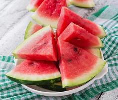 Slices of juicy and tasty watermelon on a white plate photo