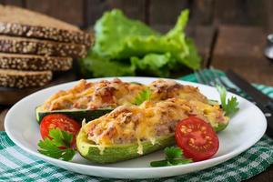 Stuffed zucchini with chicken, tomatoes and onion with cheese crust photo