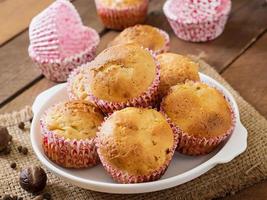 Fruit muffins with nutmeg and allspice on a wooden background photo