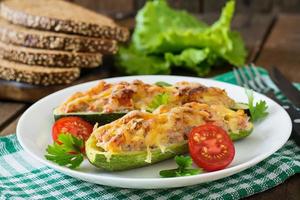 Stuffed zucchini with chicken, tomatoes and onion with cheese crust photo