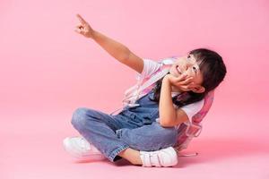 Image of Asian primary school student on pink background photo