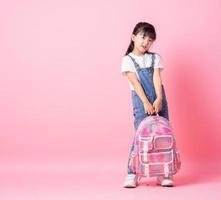 Image of Asian primary school student on pink background photo