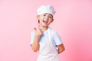 Image of Asian child practicing to be a chef photo