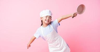 Image of Asian child practicing to be a chef photo