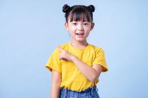 Image of Asian child posing on blue background photo