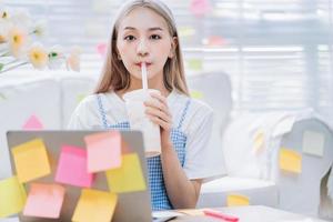 Young Asian girl using laptop at home photo