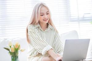 Young Asian girl working at home photo