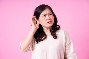 Image of middle aged Asian woman on pink background photo