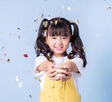 Portrait of Asian child posing on blue background photo
