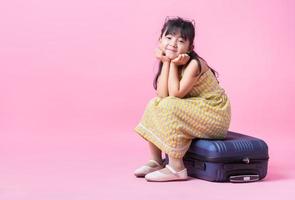 Image of Asian child with suitcase, summer concept photo