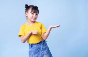 Image of Asian child posing on blue background photo