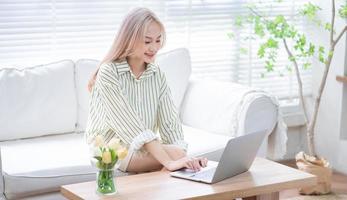 Young Asian girl working at home photo