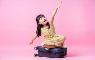 Image of Asian child with suitcase, summer concept photo