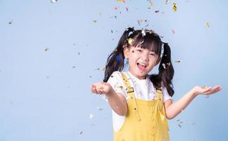 Portrait of Asian child posing on blue background photo