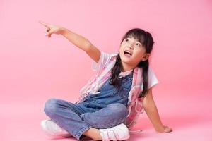 Image of Asian primary school student on pink background photo