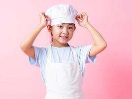 Image of Asian child practicing to be a chef photo