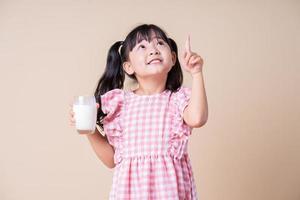 Image of Asian child drinking milk on background photo