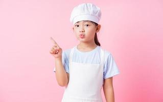 Image of Asian child practicing to be a chef photo