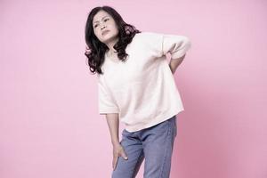 Image of middle aged Asian woman on pink background photo
