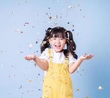 Portrait of Asian child posing on blue background photo