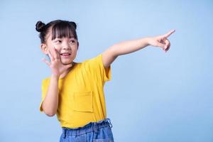 Image of Asian child posing on blue background photo