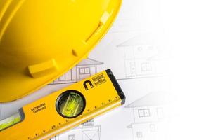 Architectural house plan project blueprint with yellow helmet and engineering construction tools. photo