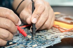 Technician repairing inside of mobile phone. Integrated Circuit. the concept of data, hardware, technology. photo