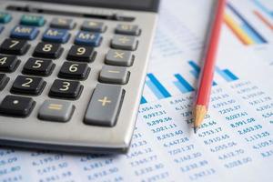Calculator on chart and graph spreadsheet paper. Finance development, Banking Account, Statistics, Investment Analytic research data economy, Stock exchange trading, Business company concept. photo