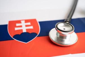 Black stethoscope on Slovakia flag background, Business and finance concept. photo