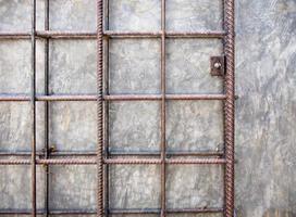 The old concrete walls are decorated with Wrought iron grating photo