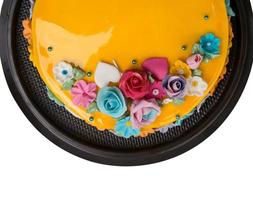 Closeup Top view Mango jam cake decorations with Colorful Icing fruits photo