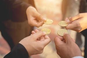 hand of a businessman holding bitcoins and solve puzzles together A business team assembles a bitcoin puzzle, a business group that wants to collect puzzle pieces. photo