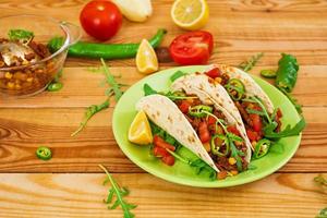 Mexican tacos with beef in tomato sauce photo