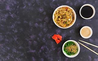 Udon noodles with seafood on dark background. Top view. photo