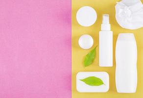 Set cosmetics SPA.  Mockup on pink-yellow background, place you design. Top view photo